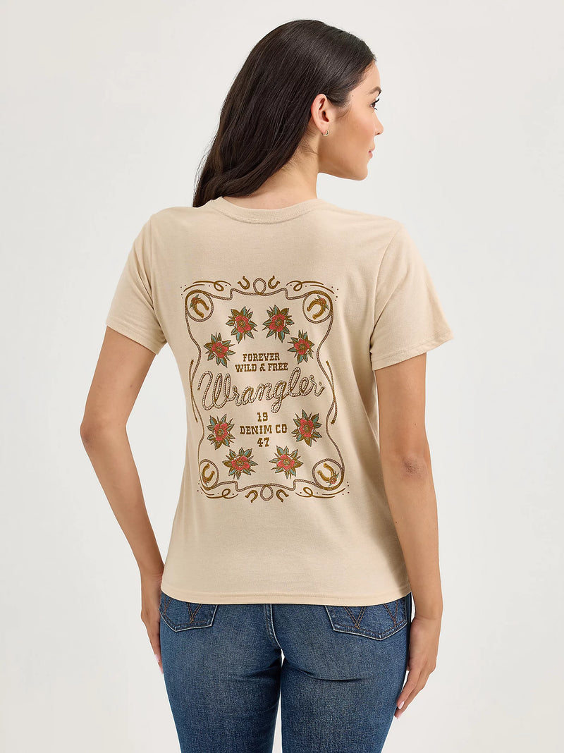 Woman wearing a beige t-shirt with Wrangler logo and text on a plain background