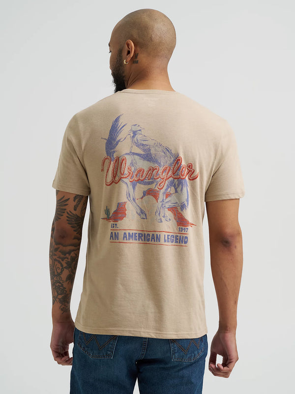 Man wearing a beige t-shirt with a graphic design and 'Wrangler' branding on the back.