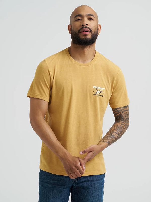 Man wearing a yellow t-shirt with a logo on a plain background