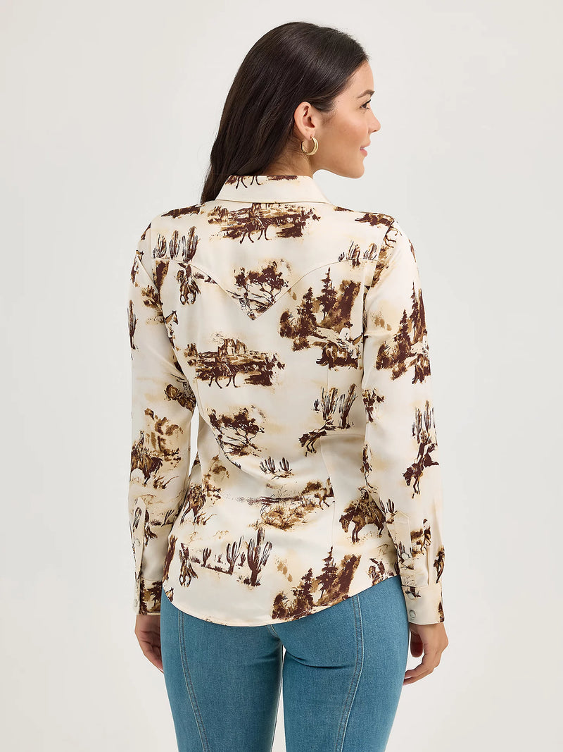 Woman wearing a patterned blouse with a neutral background