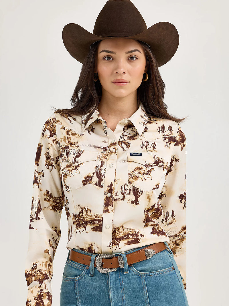 Woman wearing a cowboy hat, patterned shirt, and jeans on a white background