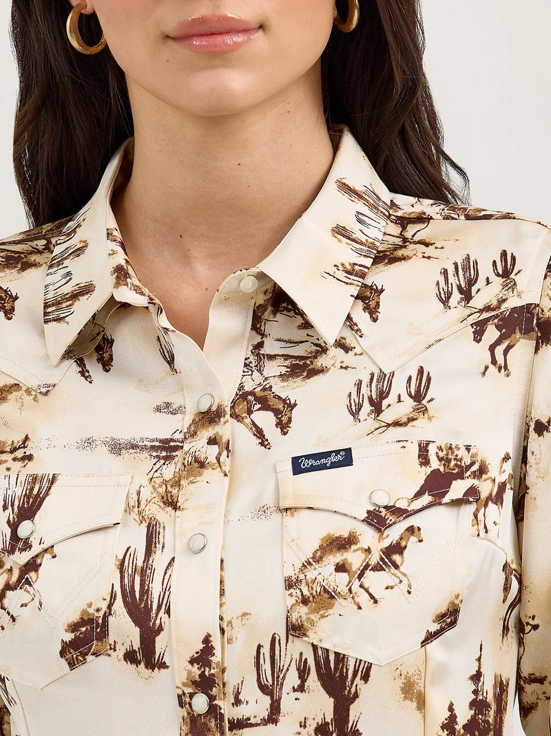 Close-up of a person wearing a patterned shirt with desert-themed design and 'Roper' branding.