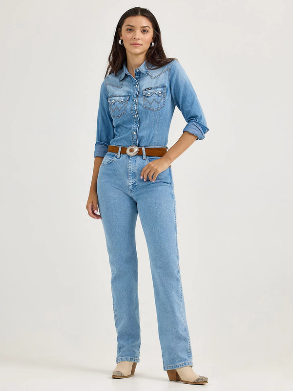 Woman wearing a denim shirt and jeans on a white background