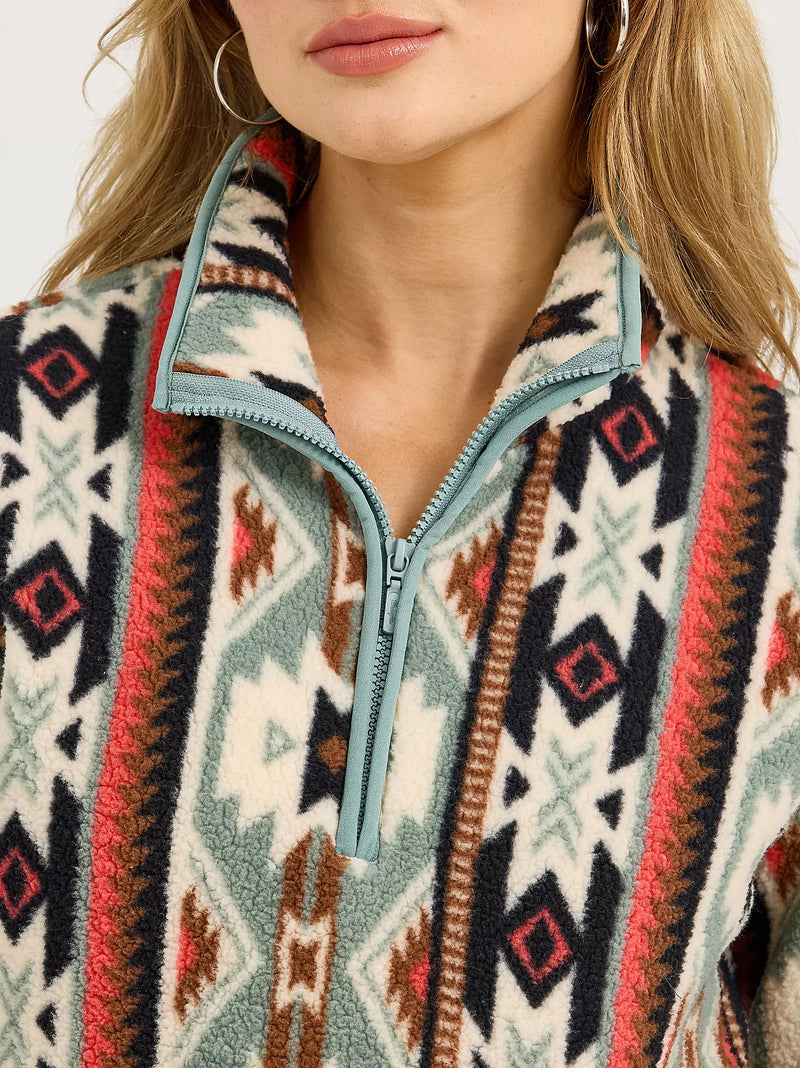 Close-up of a person wearing a patterned jacket with a zipper.