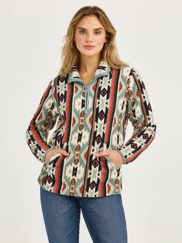 Woman wearing a patterned pullover with a plain background