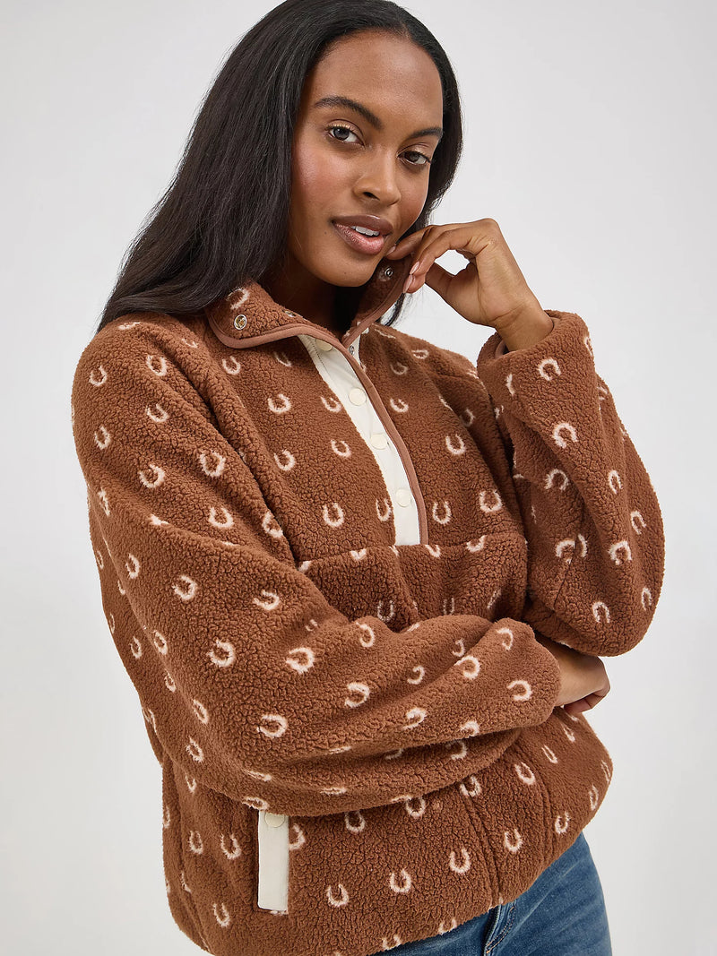 Woman wearing a brown fleece pullover with a pattern on a white background