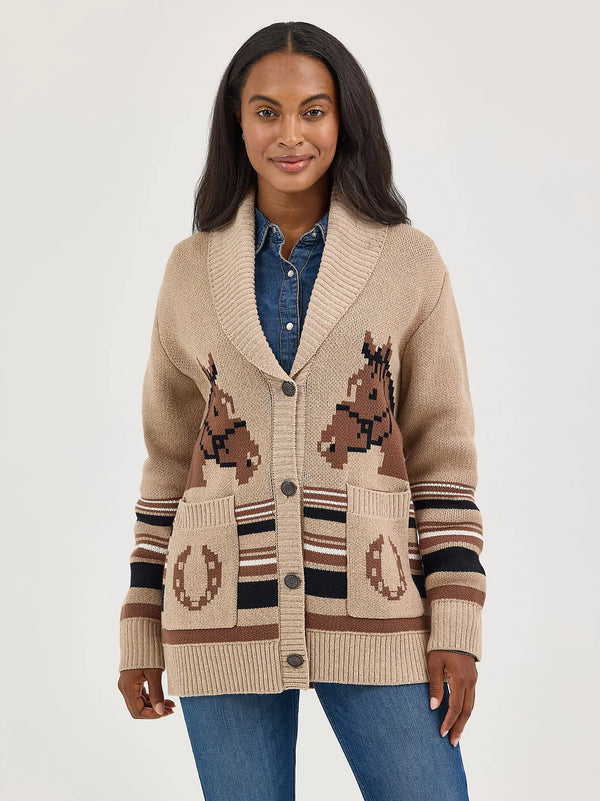 Woman wearing a beige cardigan with horse and horseshoe patterns on a white background