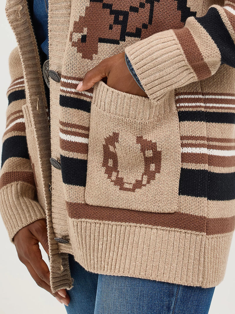 Close-up of a person wearing a patterned cardigan with a visible brand logo.