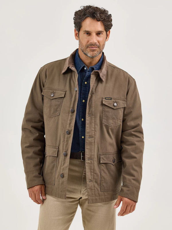 Man wearing a brown jacket over a blue shirt on a white background