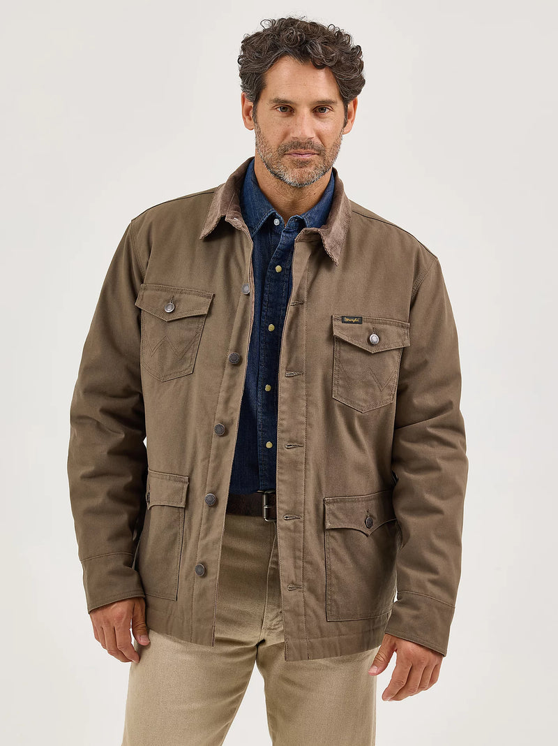 Man wearing a brown jacket over a blue shirt on a white background