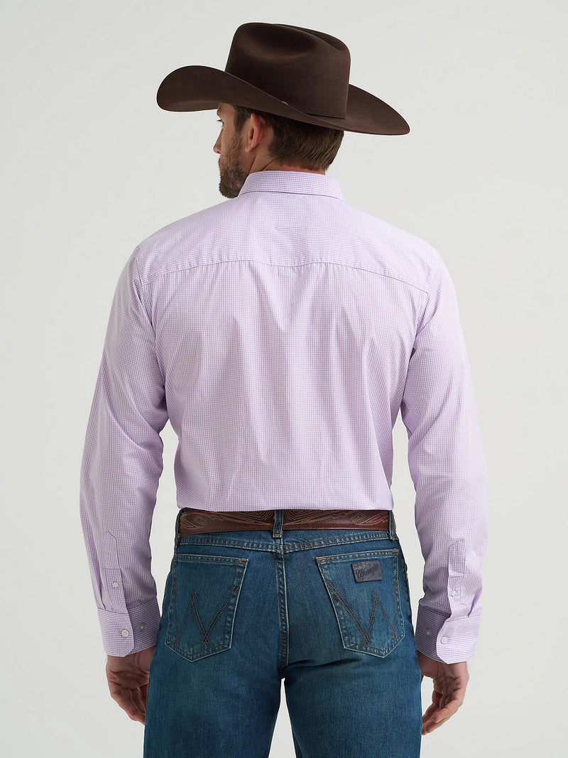 Man wearing a purple shirt, blue jeans, and a brown cowboy hat on a white background