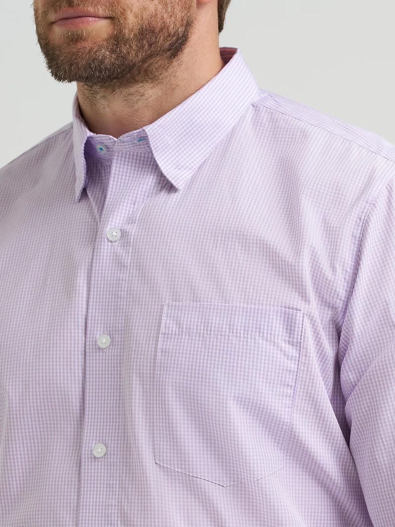 Close-up of a man wearing a light purple checkered shirt against a plain background
