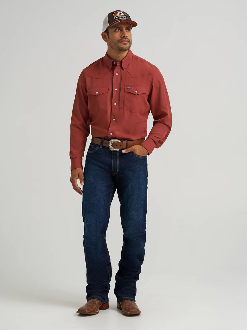Man wearing a red shirt, blue jeans, and a cap on a white background