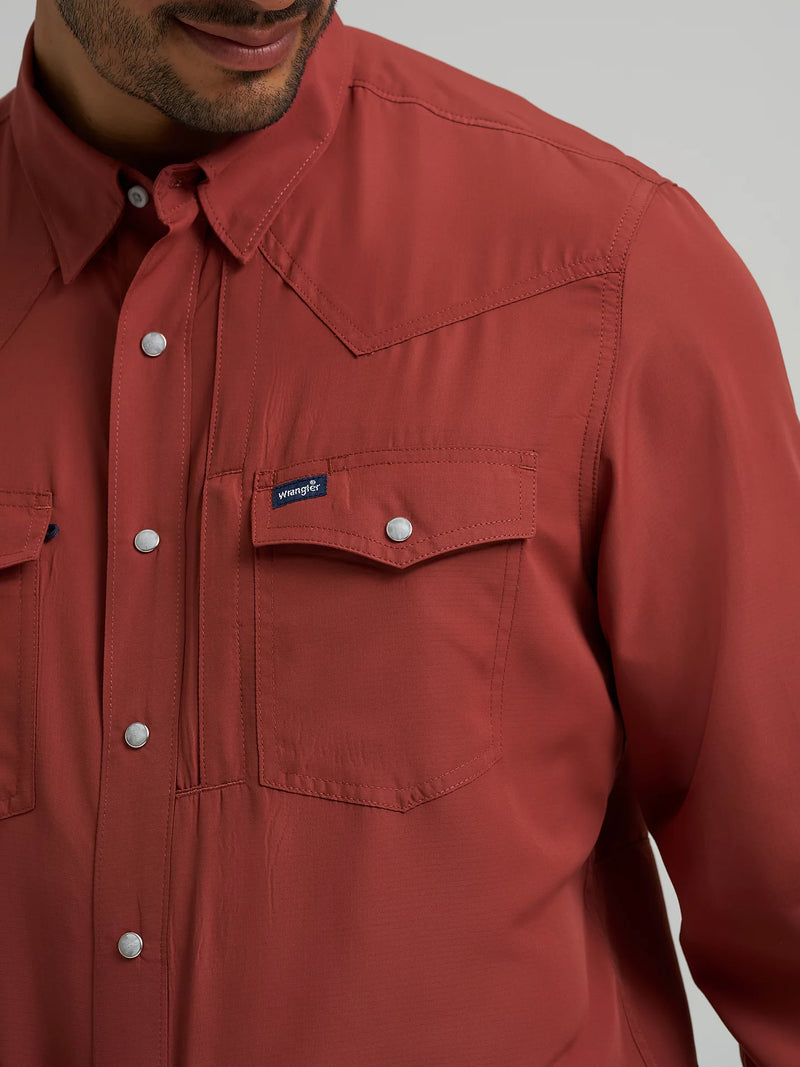 Close-up of a red shirt with a brand logo on a gray background