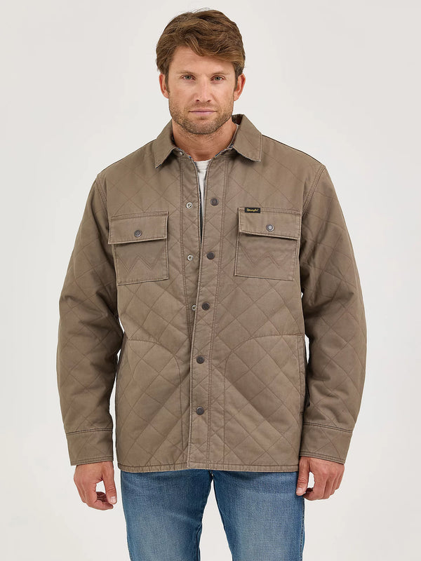 Man wearing a brown quilted jacket on a white background