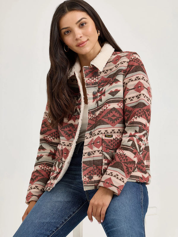 Woman wearing a patterned jacket with a white background