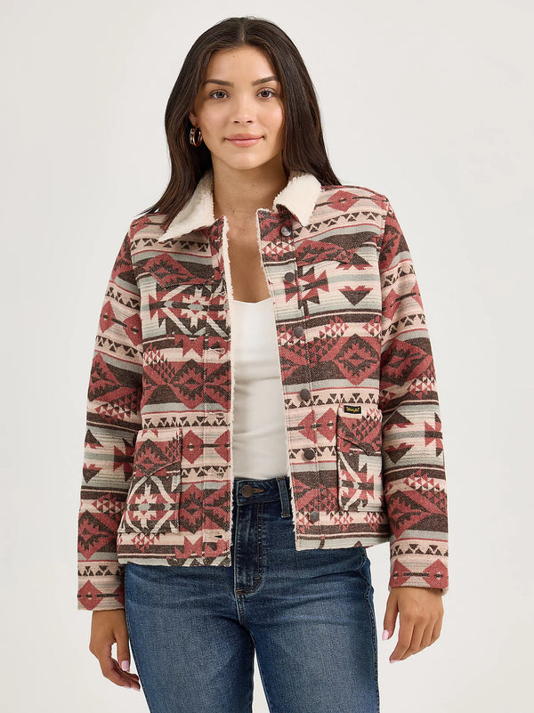 Woman wearing a patterned jacket with a white background