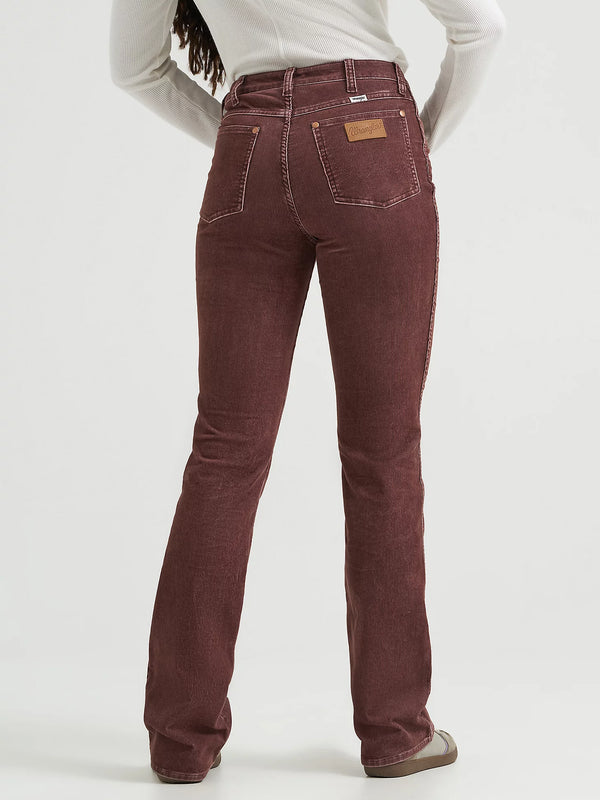 Brown jeans worn by a person on a white background