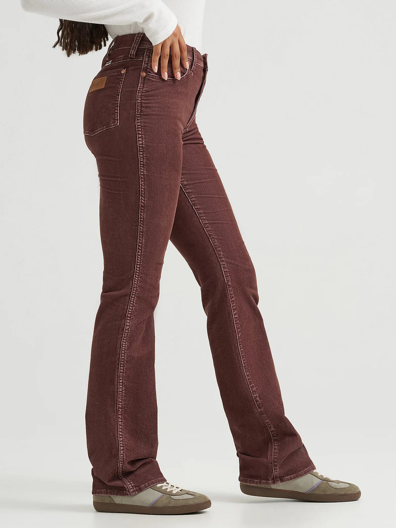 Brown jeans worn by a person on a white background