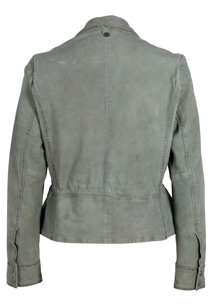 Woman wearing sage color leather jacket with button front, double breast pocket, waist cinch and button cuff