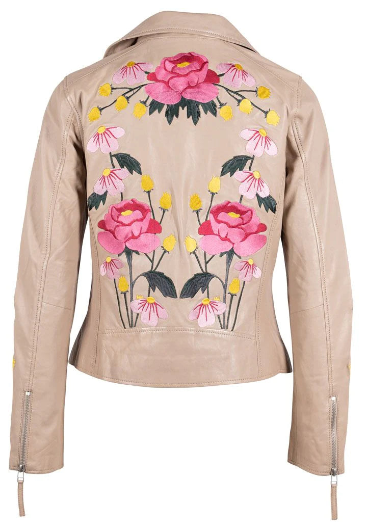 Woman wearing beige leather jacket with pink floral embroidery with asymmetrical zipper on the front