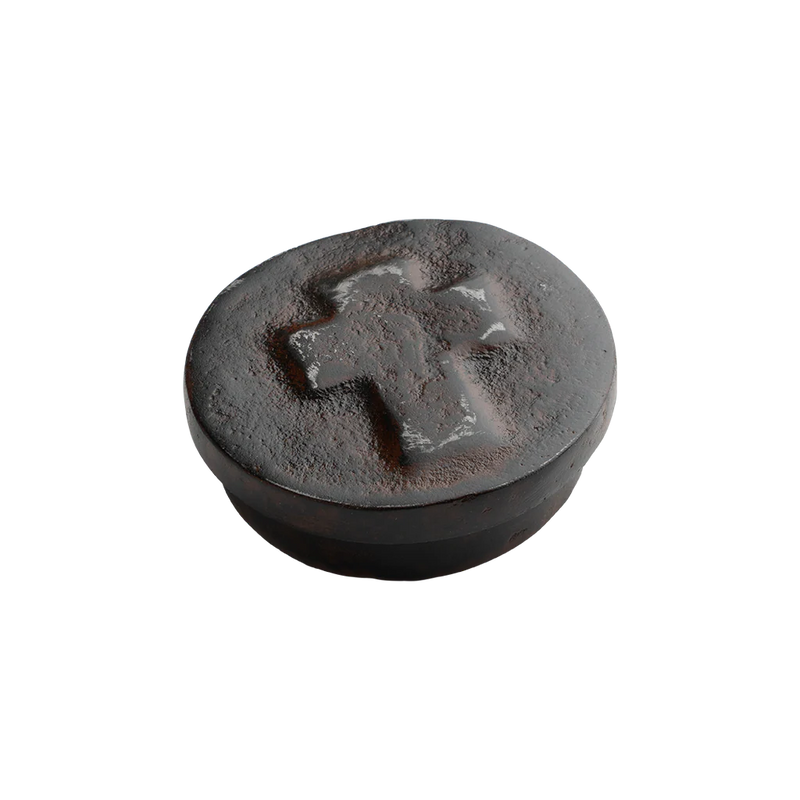 Round stone with a cross engraving on a white background