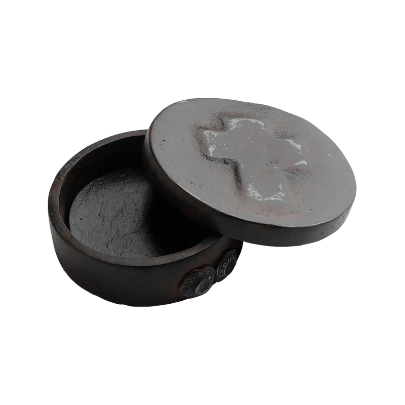 Black stone incense holder with lid on a white background