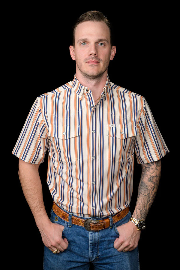 Man wearing a striped shirt and jeans against a black background