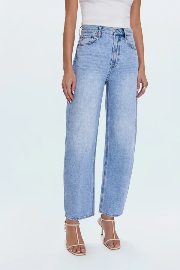 Light blue jeans worn by a person on a white background