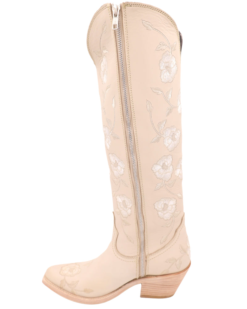 Women's tall cream color boot with embroidered white flowers all over with zipper on the inside of the boots for easy wearability 