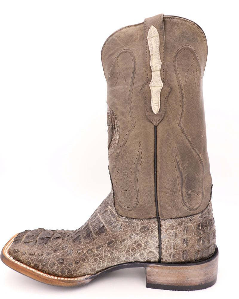 The vamp is constructed of rugged hornback caiman leather with a natural finish. The shaft is constructed of dark brown leather with a lone star inlay in the front