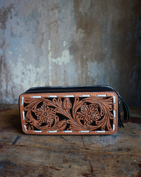 Mini plus travel jewelry case with floral tooled leather and white bucksitich lacing top, with hair on cowhide, black leather or dark chocolate brown leather with black velvet interior.