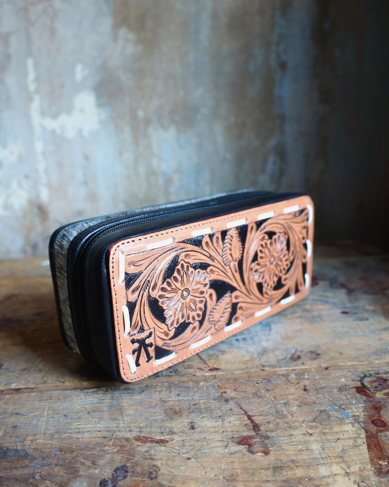 Mini plus travel jewelry case with floral tooled leather and white bucksitich lacing top, with hair on cowhide, black leather or dark chocolate brown leather with black velvet interior.