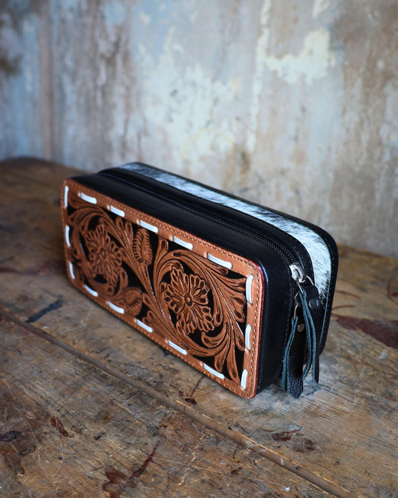 Mini plus travel jewelry case with floral tooled leather and white bucksitich lacing top, with hair on cowhide, black leather or dark chocolate brown leather with black velvet interior.