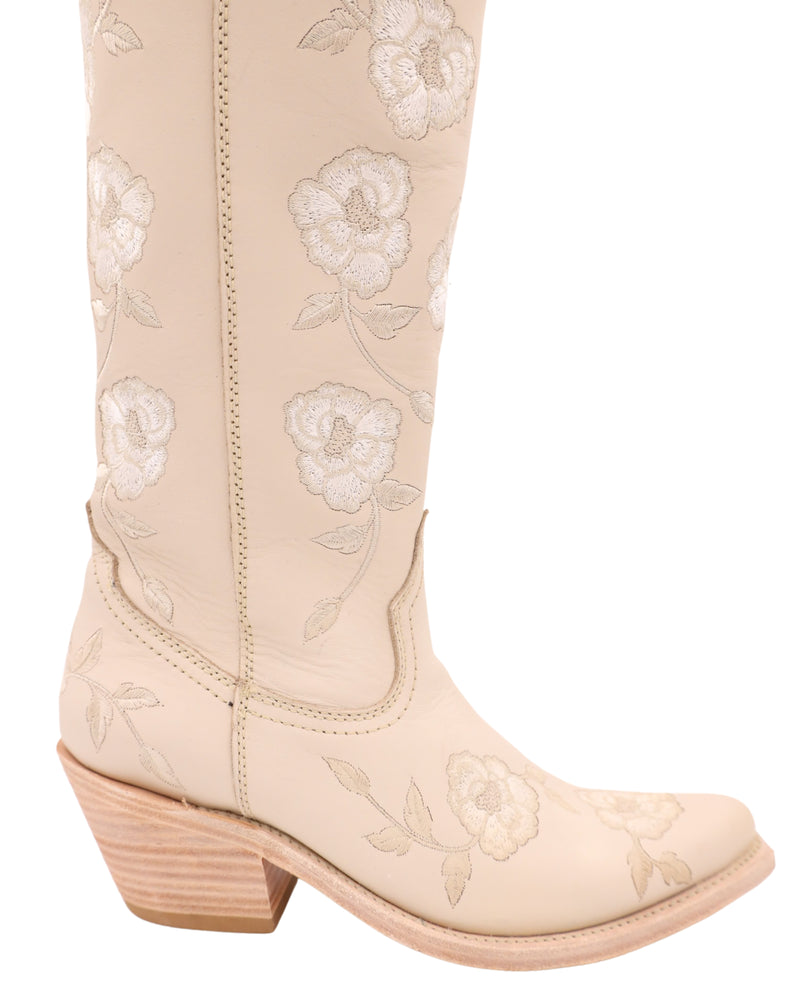 Women's tall cream color boot with embroidered white flowers all over with zipper on the inside of the boots for easy wearability 