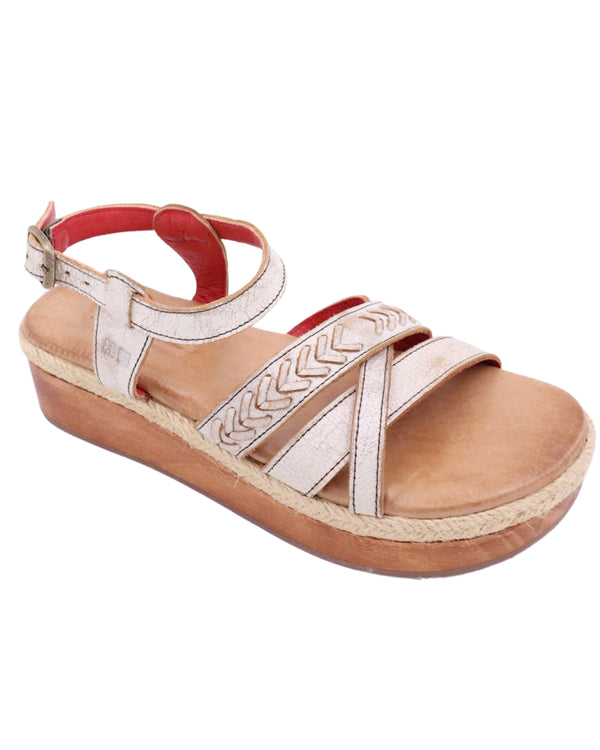 Platform sandal with white leather straps on the top of the foot and strap around the ankle 