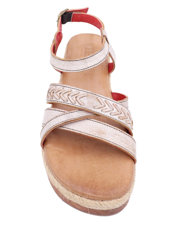 Platform sandal with white leather straps on the top of the foot and strap around the ankle