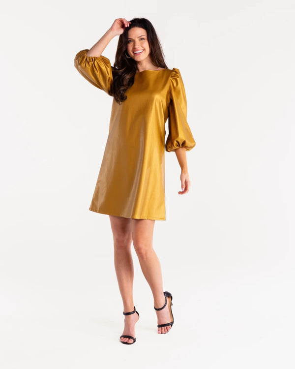 Woman wearing bronze vegan leather dress with balloon sleeves