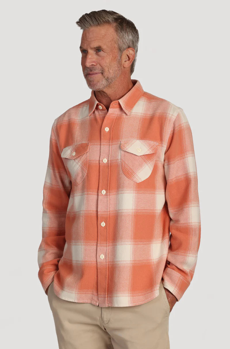Man wearing orange button up plaid shirt with double breast pockets