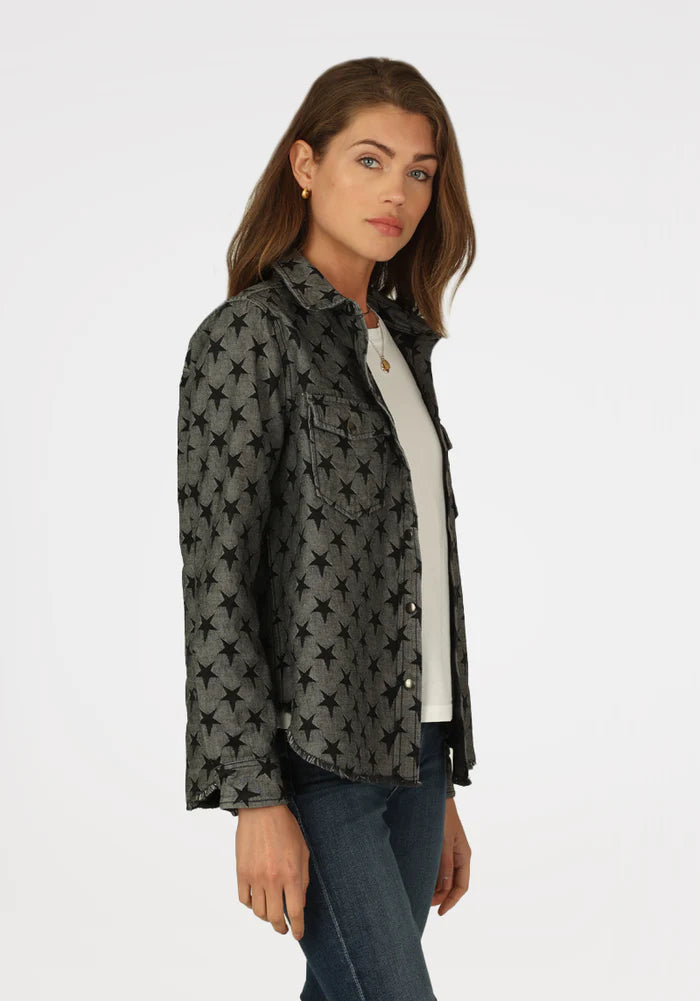 Woman wearing grey jacket with black stars all over with double breast pockets