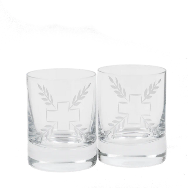 Small clear glasses in a set of two that are etched in a cross and leaf pattern