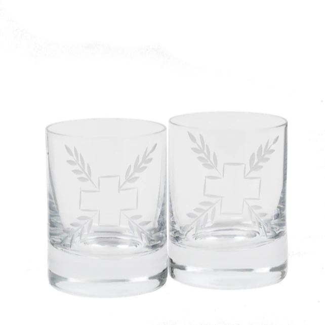Small clear glasses in a set of two that are etched in a cross and leaf pattern