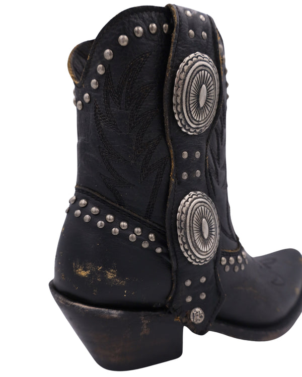 Black cowboy bootie with studs, conchos and distressed leather all over