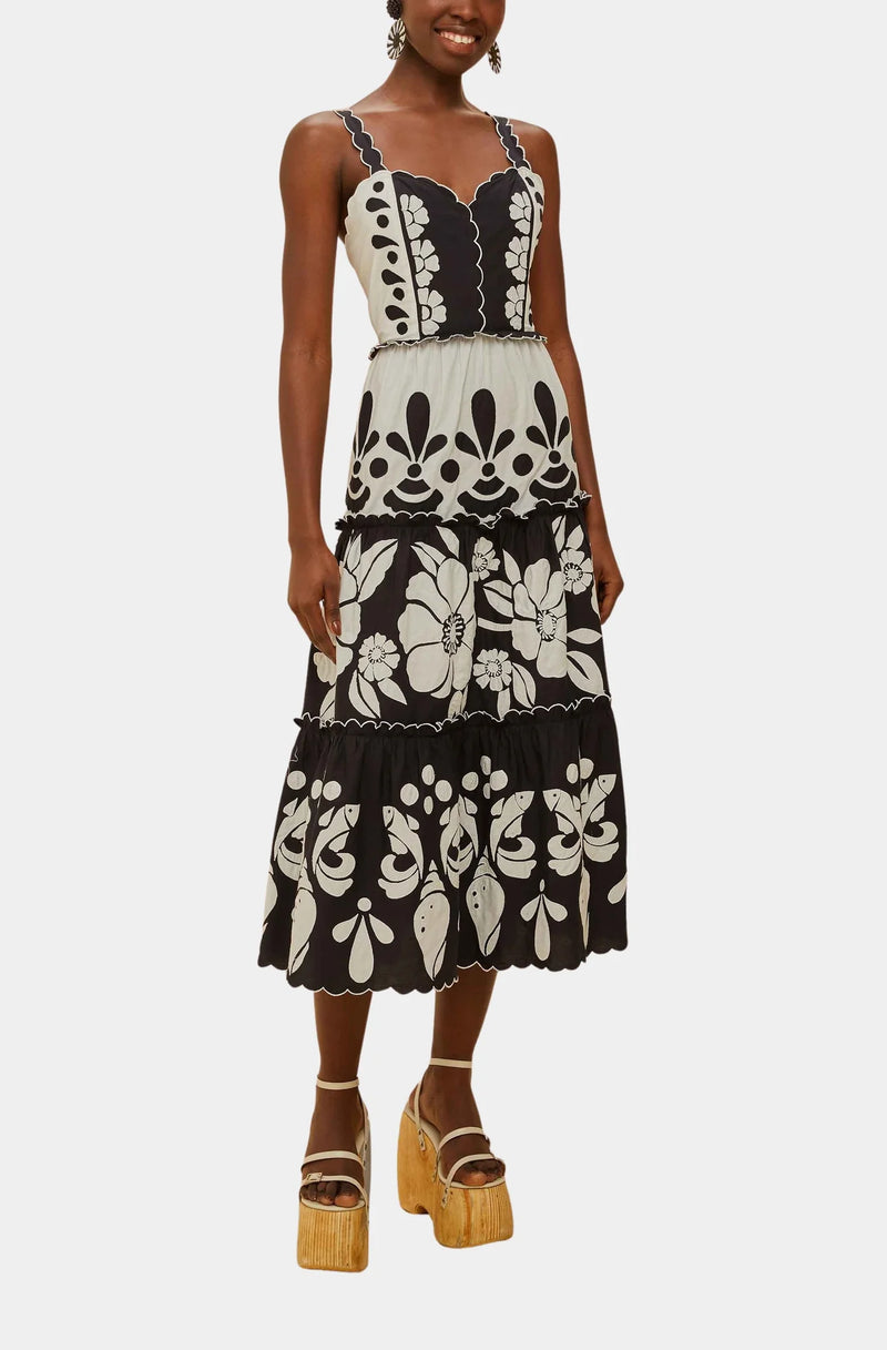 Woman wearing a black and white floral dress on a white background