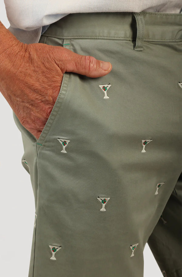 Man wearing sage green shorts with martini glasses all over
