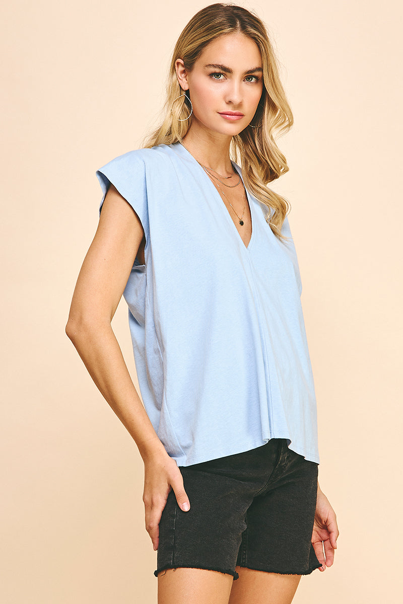 Woman wearing baby blue v neck top