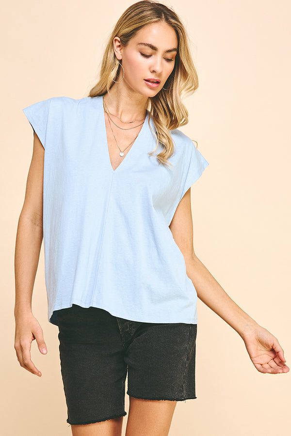 Woman wearing baby blue v neck top