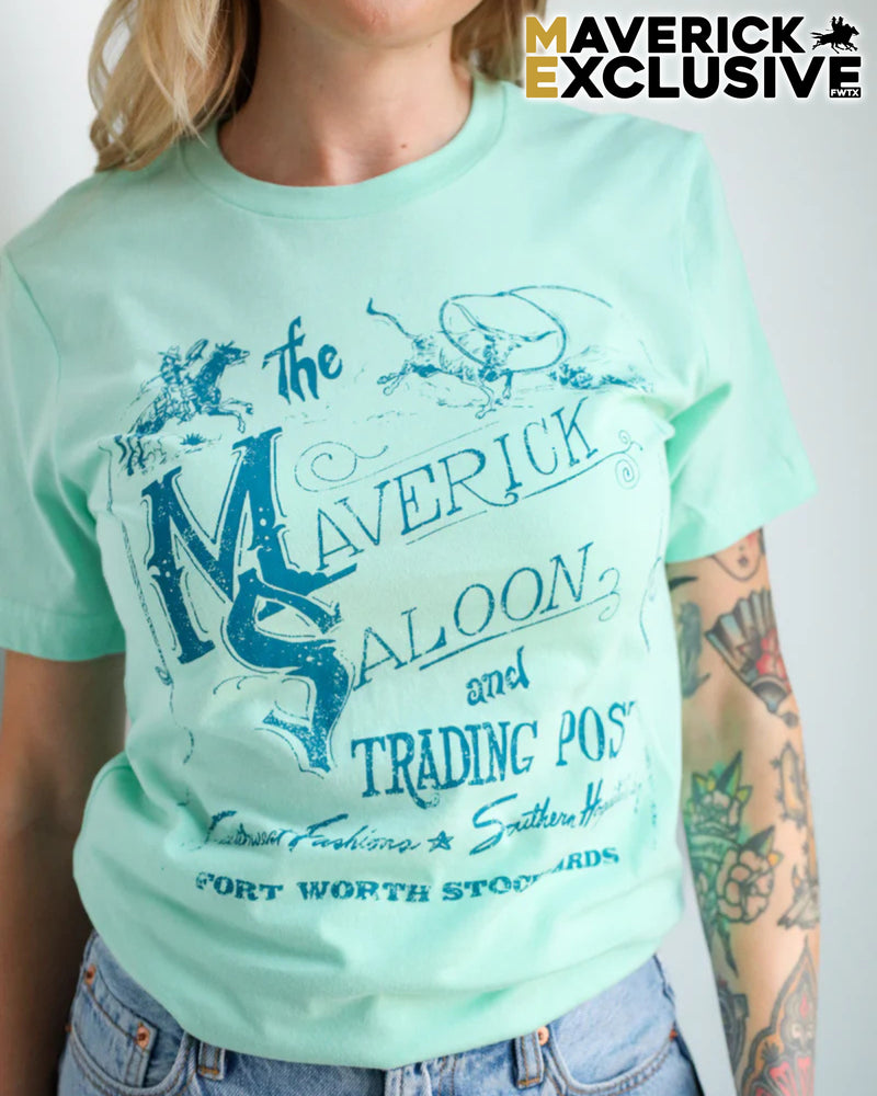 Person wearing a light green t-shirt with 'Maverick Saloon' design, with 'Maverick Exclusive' branding.