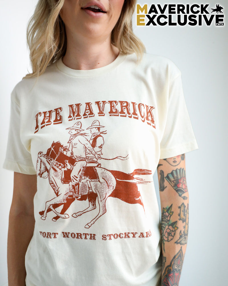 Person wearing a white t-shirt with a red graphic and text, featuring 'The Maverick Fort Worth Stockyard' design.