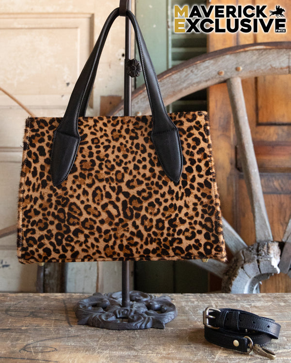 Leopard print handbag with black handles on a stand, with 'Maverick Exclusive' branding.
